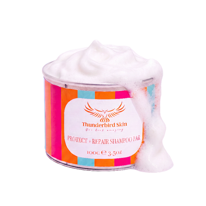 A tin of Thunderbird Skin Protect + Repair Shampoo Bar, filled with white shampoo bar and overflowing with thick white foam, set against a solid white background.