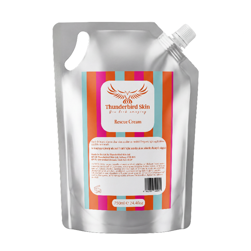 A silver resealable refill pouch of Thunderbird Skin Rescue Cream with a colorful striped label, isolated on a white background.