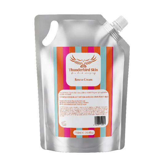 A silver resealable refill pouch of Thunderbird Skin Rescue Cream with a colorful striped label, isolated on a white background.