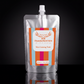 A 300ml silver foil pouch of Thunderbird Skin Skin Calming Tonic with a white cap, set against a dark reflective background.