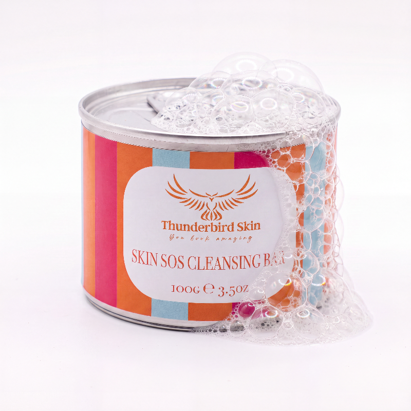 A cylindrical metal tin of Thunderbird Skin Skin SOS Cleansing Balm wrapped in clear bubble foam, set against a clean white background.