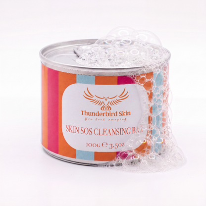 A cylindrical metal tin of Thunderbird Skin Skin SOS Cleansing Balm wrapped in clear bubble foam, set against a clean white background.