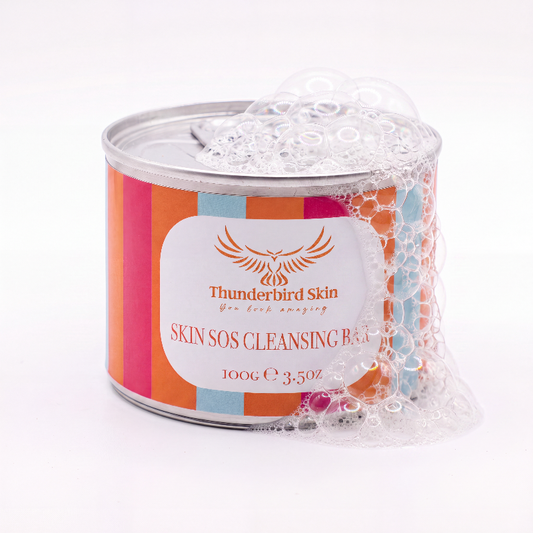 A cylindrical metal tin of Thunderbird Skin Skin SOS Cleansing Balm wrapped in clear bubble foam, set against a clean white background.